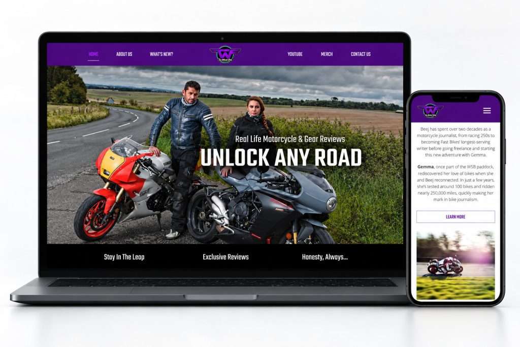 Two Wheels Feels responsive website with complete Unlock Any Road desktop hero, view 1
